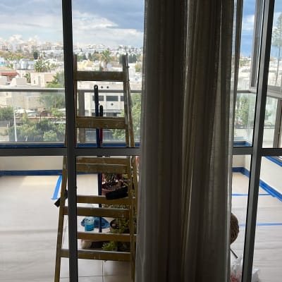 סולם, דלי צבע, קירות עם סרט הדבקה כחול