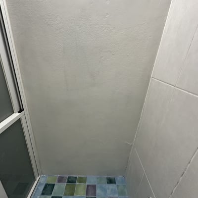 תקרת מקלחת עם אריחים צבעוניים וראש מקלחת