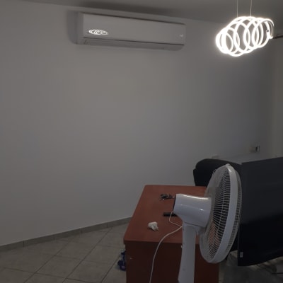 פח צבע פתוח על הרצפה ליד קיר לבן