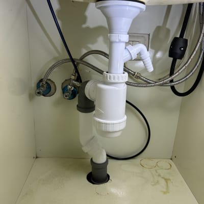 צנרת פלסטיק מתחת לכיור עם חיבורים