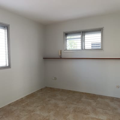 חדר ריק עם קירות צבועים ורצפת אריחים