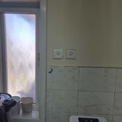 שני שקעים חשמליים על קיר מטבח ליד חלון