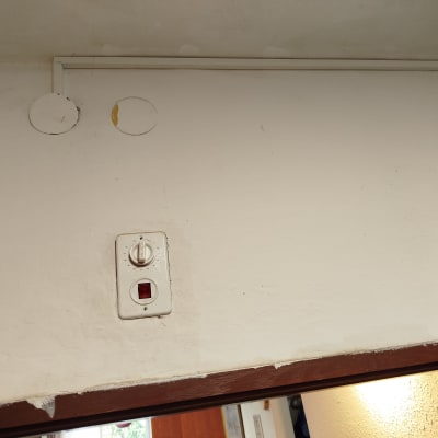 קיר עם מתג חשמלי ולוח בקרה