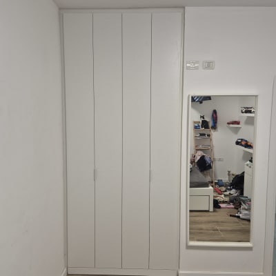 ארון בגדים לבן עם מראה בחדר שינה