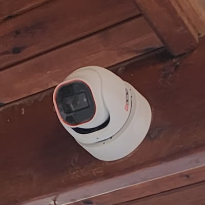 Security camera mounted on wooden ceiling