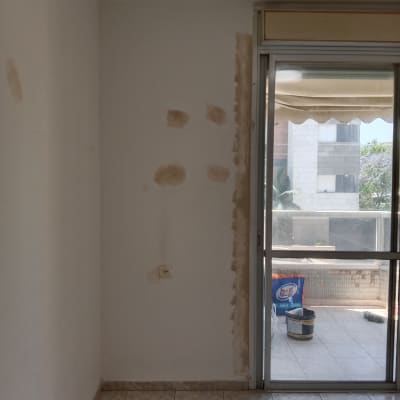 חדר עם קיר מתוקן וחומרי צביעה
