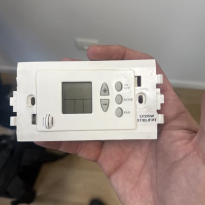 תרמוסטט של מערכת מיזוג אוויר מוחזק ביד