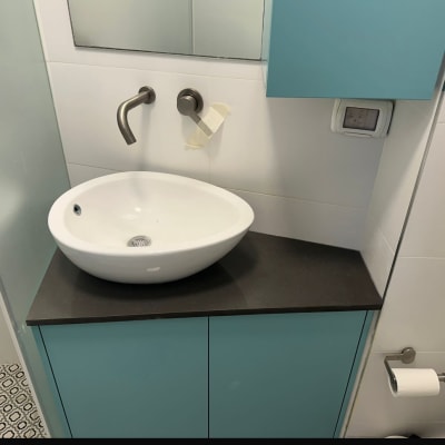 כיור עגול על משטח כהה בחדר אמבטיה