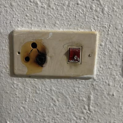 שקע חשמלי שרוף על קיר