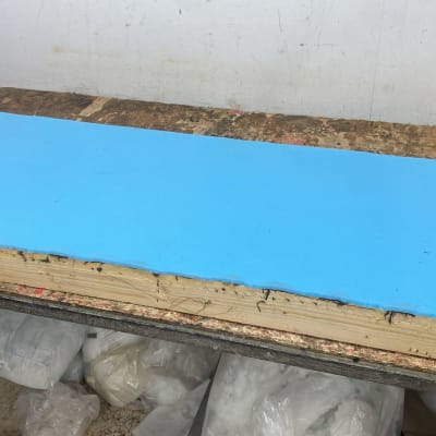 משטח ספוג כחול על שולחן עבודה עם כלים