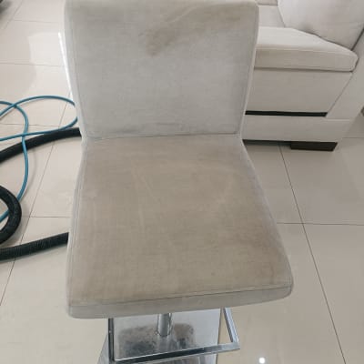 כיסא מרופד עם סימני ניקוי ליד ספה