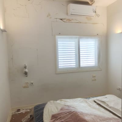חדר עם קירות מתקלפים ומאוורר תקרה
