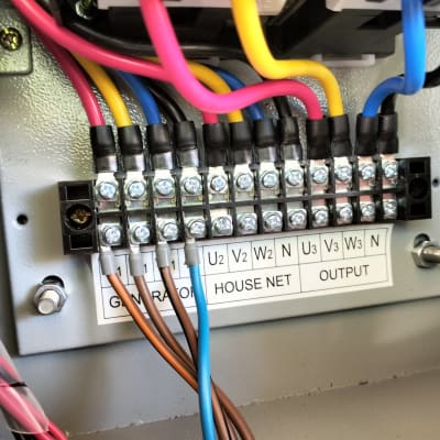 חוטי חשמל צבעוניים מחוברים ללוח חשמל עם ברגים