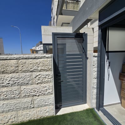 דלת אלומיניום אפורה עם תריסים אופקיים