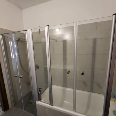 מקלחת עם דלתות זכוכית ואמבטיה