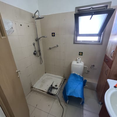חדר אמבטיה עם מקלחון וכלים סניטריים