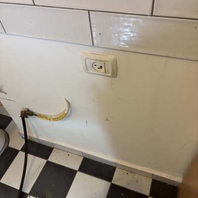 שקע חשמלי על קיר עם אריחים לבנים