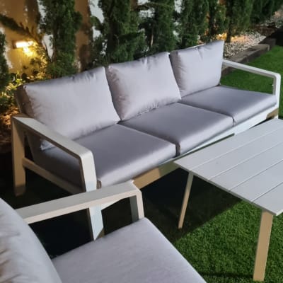 כריות ריפוד אפורות על ספה בגינה