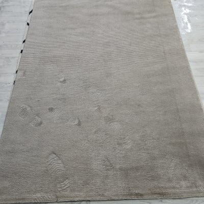 שטיח עם סימני רגליים על רצפה בהירה