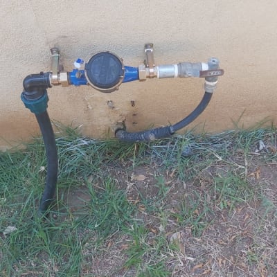 צינור מים עם מד מים מחובר לקיר