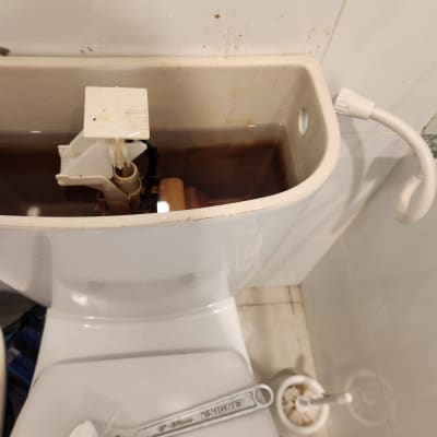 מיכל שירותים פתוח עם כלי עבודה לתיקון