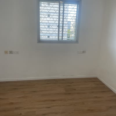 חדר מבריק ונקי עם רצפת פרקט וחלון זכוכית לאחר ניקיון