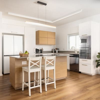 מטבח מודרני עם אי, כיסאות ועציץ