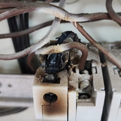 חוטים שרופים וממסר חשמלי עם סימני שריפה