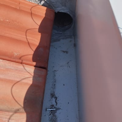 רעפים כתומים, חור עגול, ברגים על הגג