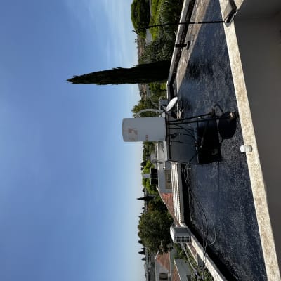 גג אטום עם חומר איטום שחור ומיכל מים