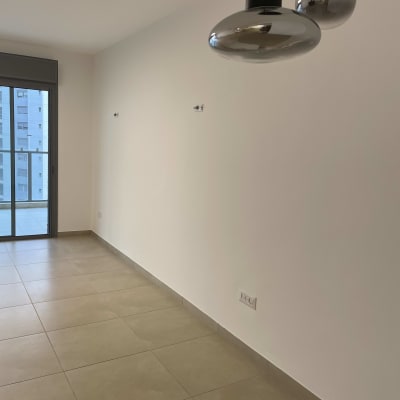 קיר לבן חלק עם רצפת אריחים חומה