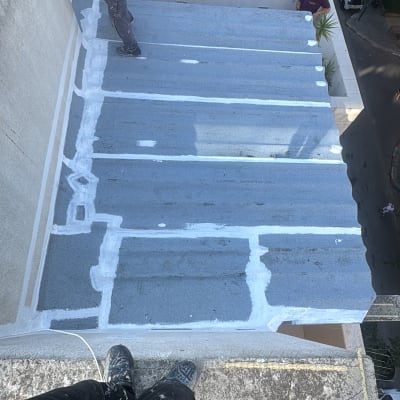 עבודת איטום על גג עם חומרי איטום וצבע