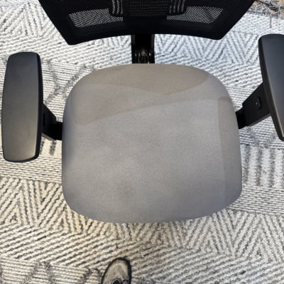 כיסא משרדי עם מושב אפור על שטיח אפור