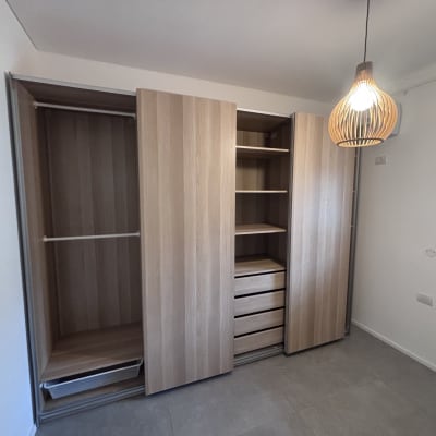 ארון עץ עם מדפים ומנורה תלויה