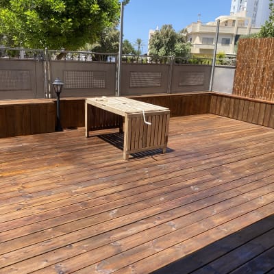 wooden deck with table and fence