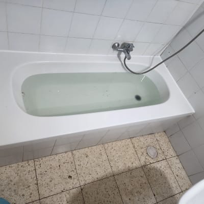 אמבטיה עם מים ורצפת אריחים