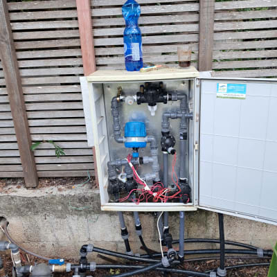 מערכת השקיה עם צינורות ושסתומים בגינה