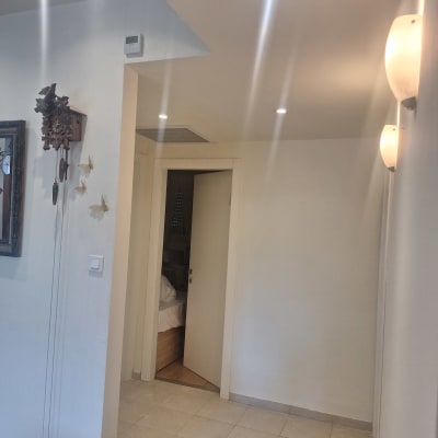 קיר גבס עם תאורה שקועה ומנורות קיר