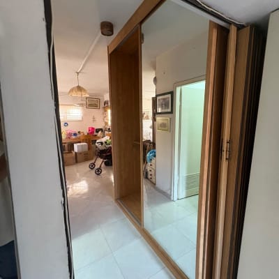 מראה גדולה בחדר עם קופסאות ועגלת תינוק