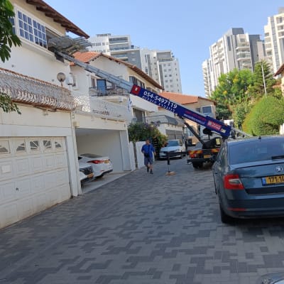 מנוף מרים חפץ לקומה עליונה של בית