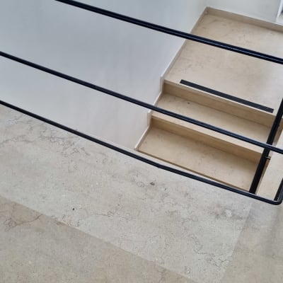 מעקה מתכת שחור לאורך גרם מדרגות פנימי