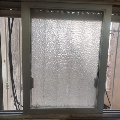 חלון עם מסגרת מתכת וזכוכית מחוספסת