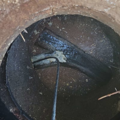 צינור ביוב עם כבל חשמלי בתוך בור