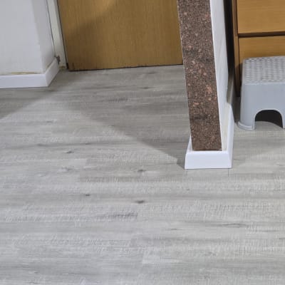 רצפת פרקט אפורה עם קיר ותמיכה לבנה