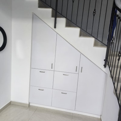 ארון לבן מתחת למדרגות עם ידיות מתכת