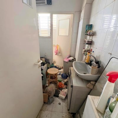 חדר אמבטיה מבולגן עם כיור וכביסה