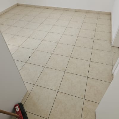 רצפה מרוצפת עם מטאטא אדום בפינה