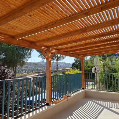 פרגולה מעץ עם נוף טבעי ברקע