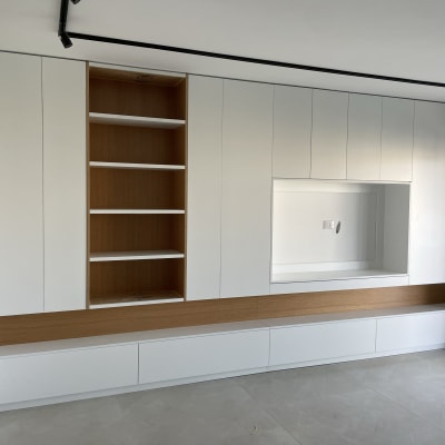 ארון קיר לבן עם מדפים פתוחים ומדף עץ