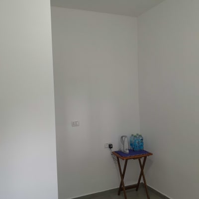 קומקום חשמלי ובקבוקי מים על שולחן קטן